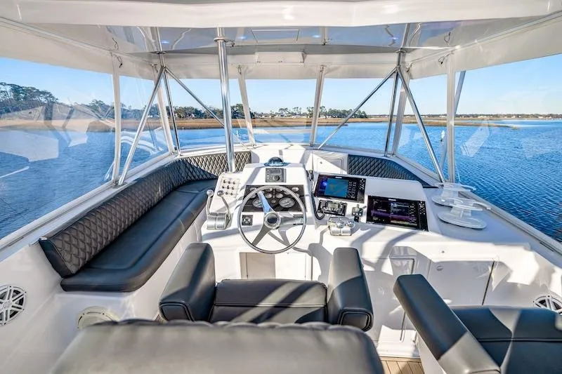 Slide: The Image of Interior view of 1991 Ocean Yachts 53 Super Sport cockpit with modern navigation equipment. - 17