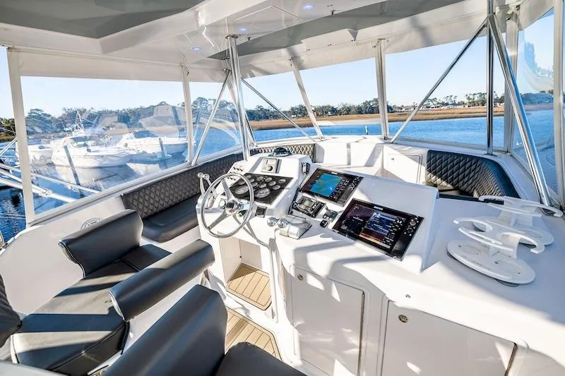 Slide: The Image of Luxurious 1991 Ocean Yachts 53 Super Sport cockpit with modern navigation equipment and seating. - 18