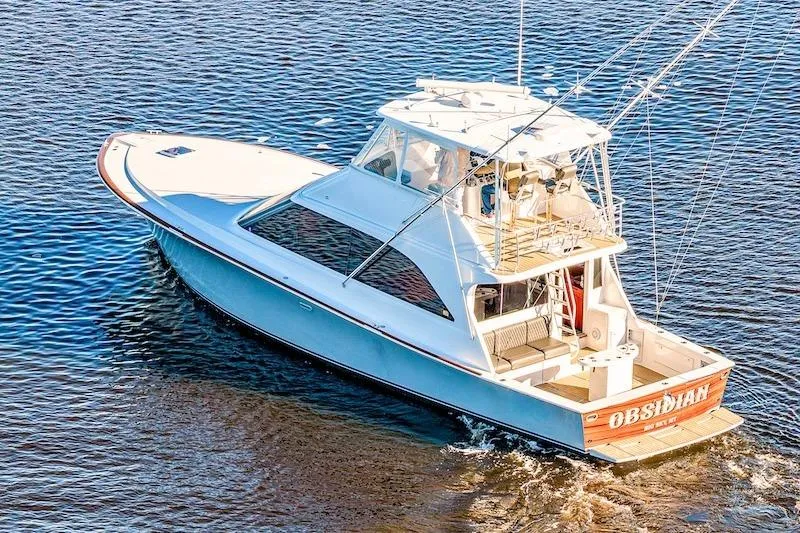 Slide: The Image of 1991 Ocean Yachts 53 Super Sport cruising on open water, showcasing sleek design and spacious deck. - 2