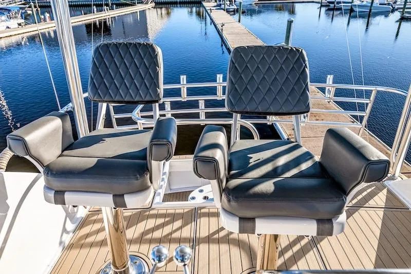 Slide: The Image of Luxury helm seats on 1991 Ocean Yachts 53 Super Sport, docked at marina. - 23