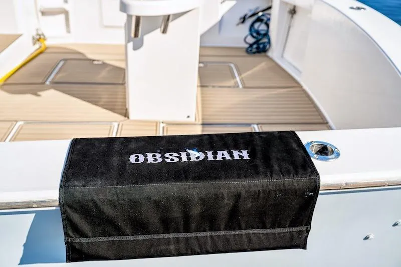 Slide: The Image of 1991 Ocean Yachts 53 Super Sport deck with "Obsidian" cover, featuring sleek design. - 24