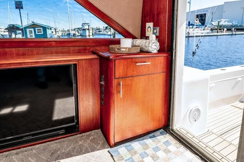 Slide: The Image of Interior of 1991 Ocean Yachts 53 Super Sport with wooden cabinetry and marina view. - 31