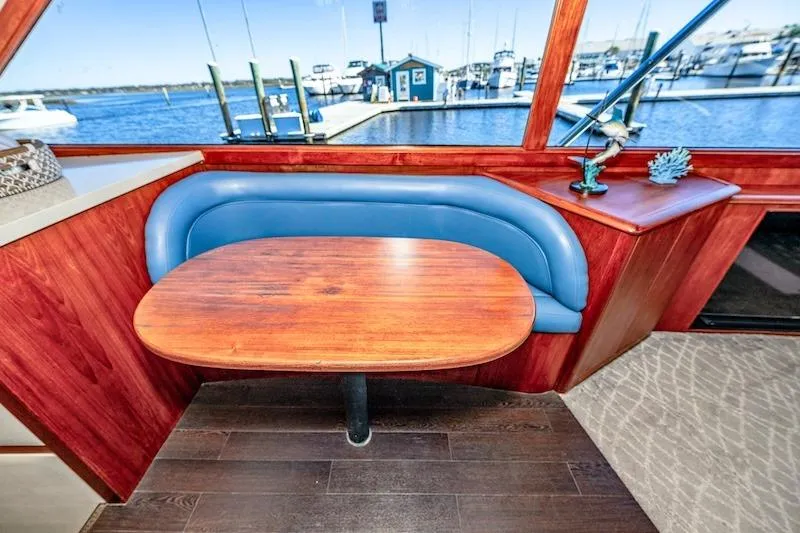 Slide: The Image of Interior of 1991 Ocean Yachts 53 Super Sport with blue seating and wooden table. - 38