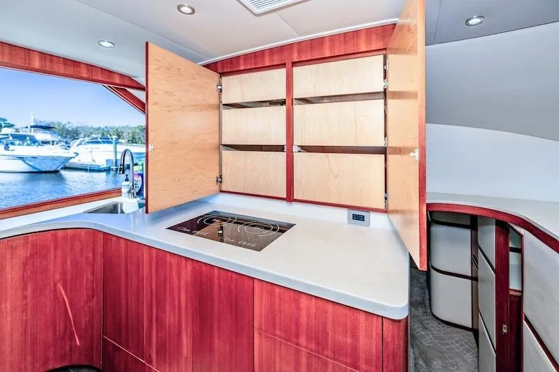 Slide: The Image of Interior of 1991 Ocean Yachts 53 Super Sport, featuring modern kitchen with open cabinets. - 44