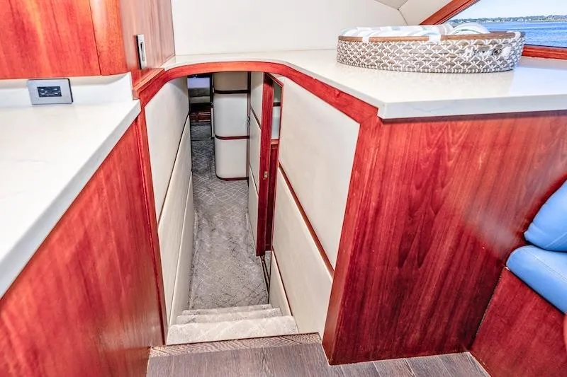 Slide: The Image of Interior view of 1991 Ocean Yachts 53 Super Sport, featuring wooden stairs and elegant design. - 45