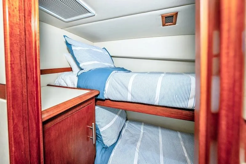 Slide: The Image of Interior cabin of 1991 Ocean Yachts 53 Super Sport with bunk beds and wooden cabinetry. - 46