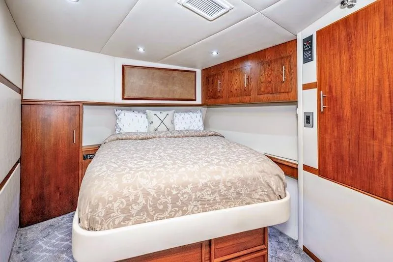 Slide: The Image of Luxurious bedroom interior of 1991 Ocean Yachts 53 Super Sport with elegant wood cabinetry. - 49