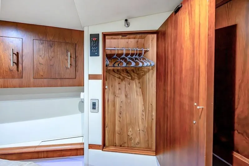 Slide: The Image of 1991 Ocean Yachts 53 Super Sport interior with wooden closet and cabinets. - 51