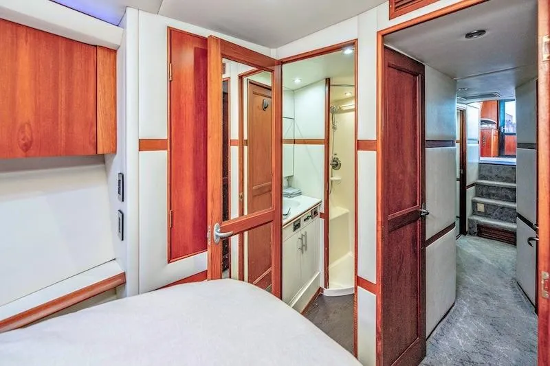 Slide: The Image of Interior of 1991 Ocean Yachts 53 Super Sport, featuring wood accents and compact bathroom. - 56