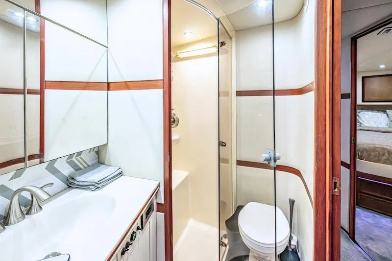 Slide: The Image of Luxurious bathroom in 1991 Ocean Yachts 53 Super Sport, featuring modern fixtures and elegant design. - 58