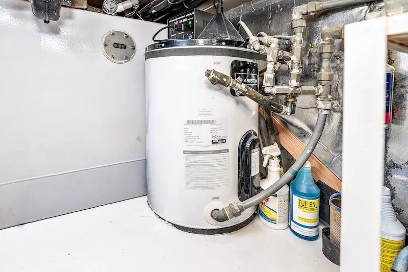 Slide: The Image of Engine room of 1991 Ocean Yachts 53 Super Sport with water heater and plumbing. - 61