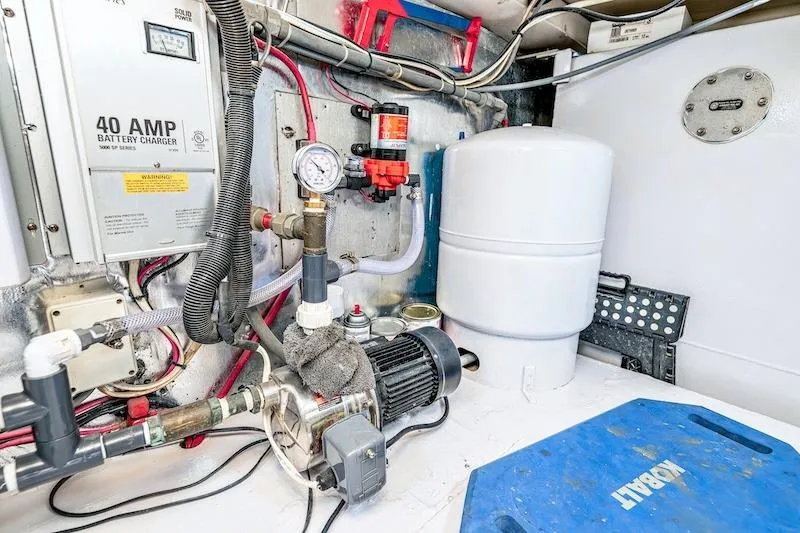 Slide: The Image of Engine room of 1991 Ocean Yachts 53 Super Sport with battery charger and equipment. - 62