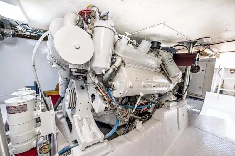 Slide: The Image of Engine room of 1991 Ocean Yachts 53 Super Sport, showcasing detailed machinery and components. - 64