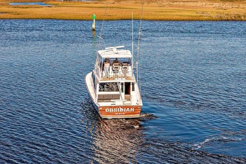 Slide: The Image of 1991 Ocean Yachts 53 Super Sport boat cruising on a calm waterway. - 7