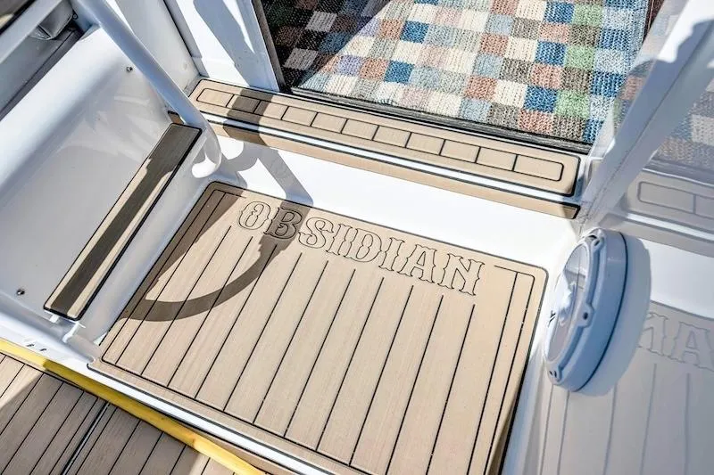 Slide: The Image of 1991 Ocean Yachts 53 Super Sport deck with "Obsidian" mat and colorful rug. - 26