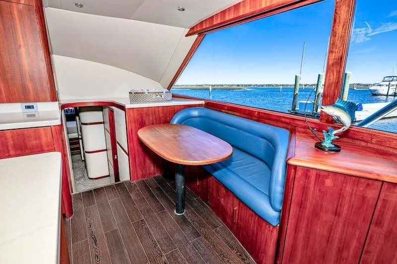 Slide: The Image of Interior of 1991 Ocean Yachts 53 Super Sport with wood finish and blue seating. - 36