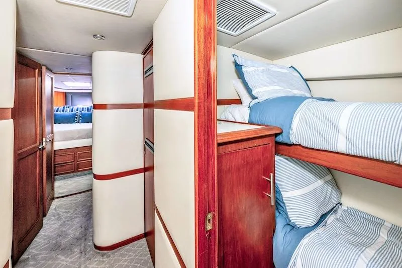 Slide: The Image of Interior of 1991 Ocean Yachts 53 Super Sport with cozy bunk beds and wood accents. - 47
