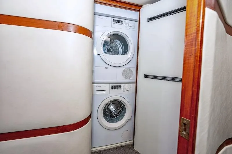 Slide: The Image of Laundry area inside 1991 Ocean Yachts 53 Super Sport, featuring stacked washer and dryer. - 48