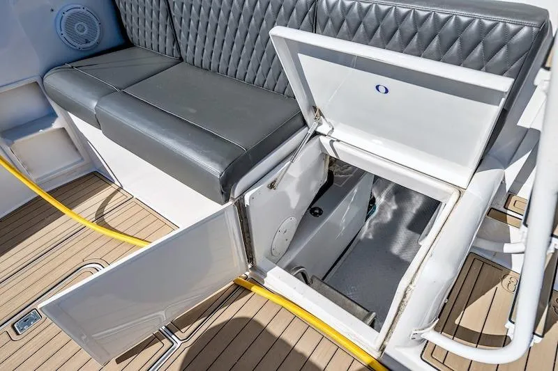 Slide: The Image of 1991 Ocean Yachts 53 Super Sport interior with open storage compartment and cushioned seating. - 59