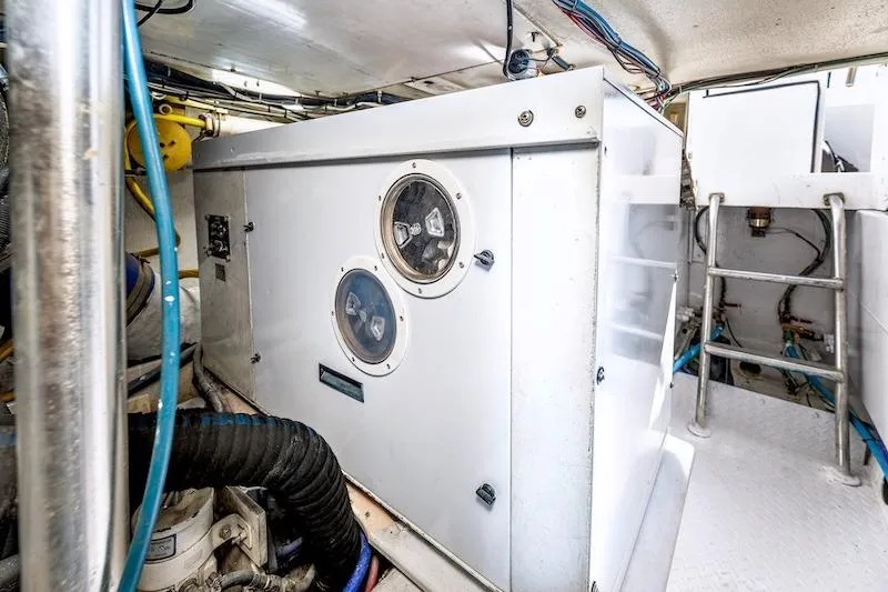 Slide: The Image of Engine room of 1991 Ocean Yachts 53 Super Sport, featuring mechanical equipment and wiring. - 66