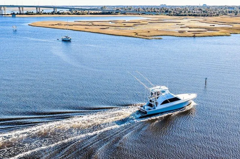 Slide: The Image of 1991 Ocean Yachts 53 Super Sport cruising on a scenic waterway. - 8