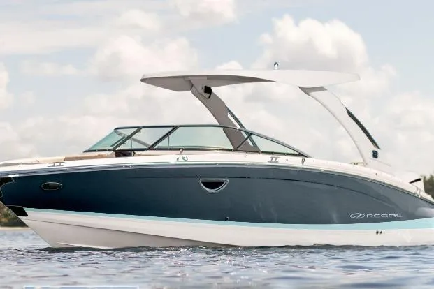 Slide: The Image of 2026 Regal LX6 boat on water, sleek design, blue and white exterior. - 0