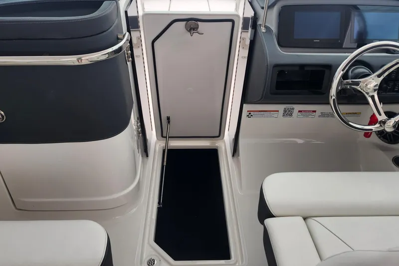 Slide: The Image of 2026 Regal LX6 boat interior with steering wheel and seating area. - 18