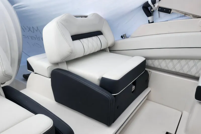 Slide: The Image of 2026 Regal LX6 boat interior with luxurious white and black seating. - 23