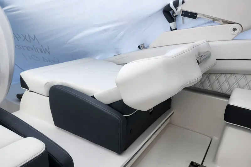 Slide: The Image of 2026 Regal LX6 boat interior with white leather seating and adjustable armrest. - 25