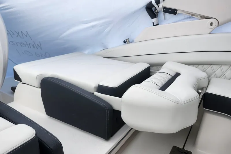 Slide: The Image of Luxurious seating on a 2026 Regal LX6 boat, featuring white and black upholstery. - 26