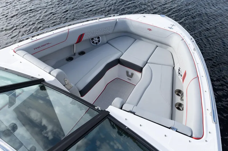 Slide: The Image of Manufacturer Provided Image: Luxurious 2026 Regal LX6 boat interior with sleek seating and cup holders on water. - 6