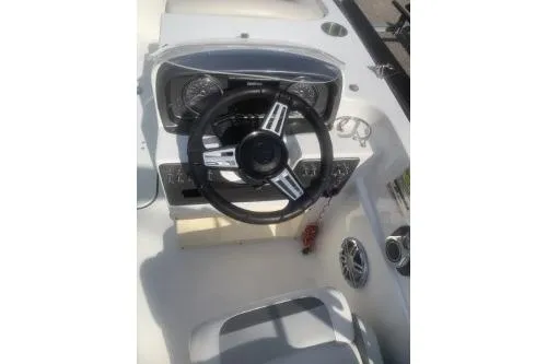 Slide: The Image of 2023 Hurricane SunDeck Sport 188 OB boat dashboard with steering wheel and controls. - 5