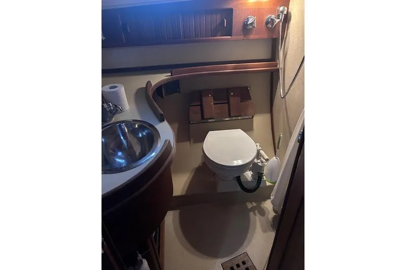 Slide: The Image of 1994 Island Packet 320 yacht bathroom with sink, toilet, and shower fixtures. - 11