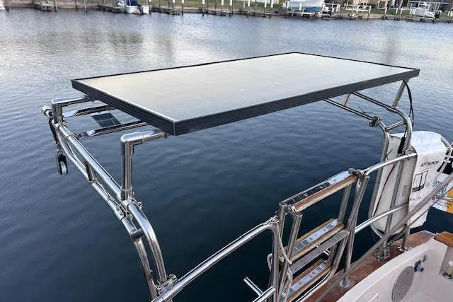 Slide: The Image of Solar panel on 1994 Island Packet 320 sailboat, docked by calm water. - 2