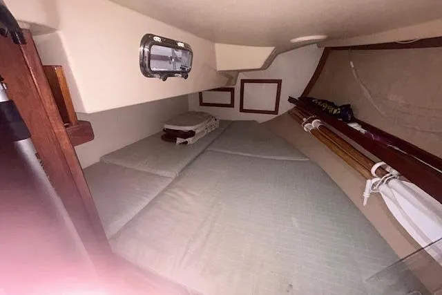 Slide: The Image of Cozy cabin interior of 1994 Island Packet 320 sailboat with bedding and storage. - 7