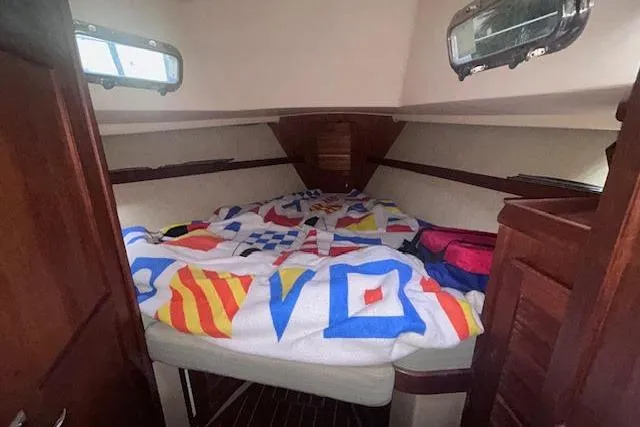Slide: The Image of Cozy cabin interior of 1994 Island Packet 320 sailboat with nautical-themed bedding. - 8
