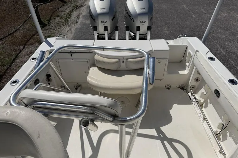 Slide: The Image of 2005 Triton 2486 CC boat interior with dual Honda 150 engines, featuring seating and railing. - 12