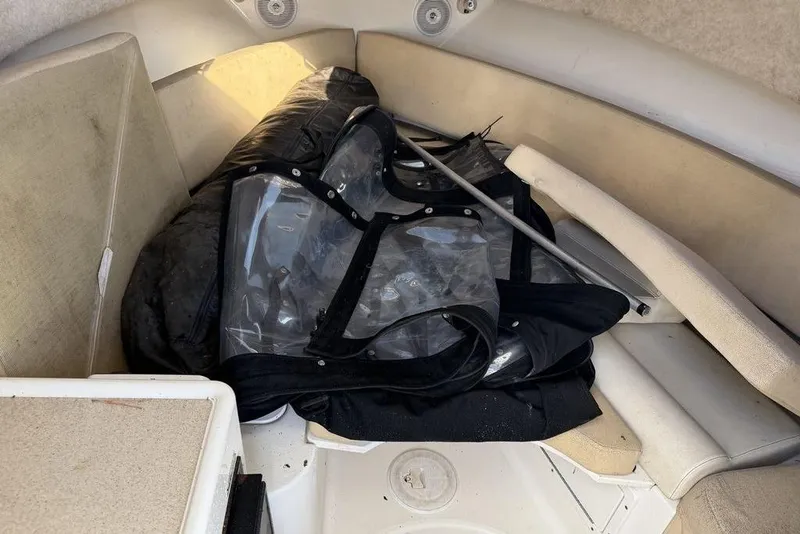 Slide: The Image of 2005 Triton 2486 CC boat interior with cushions and clear plastic cover. - 15