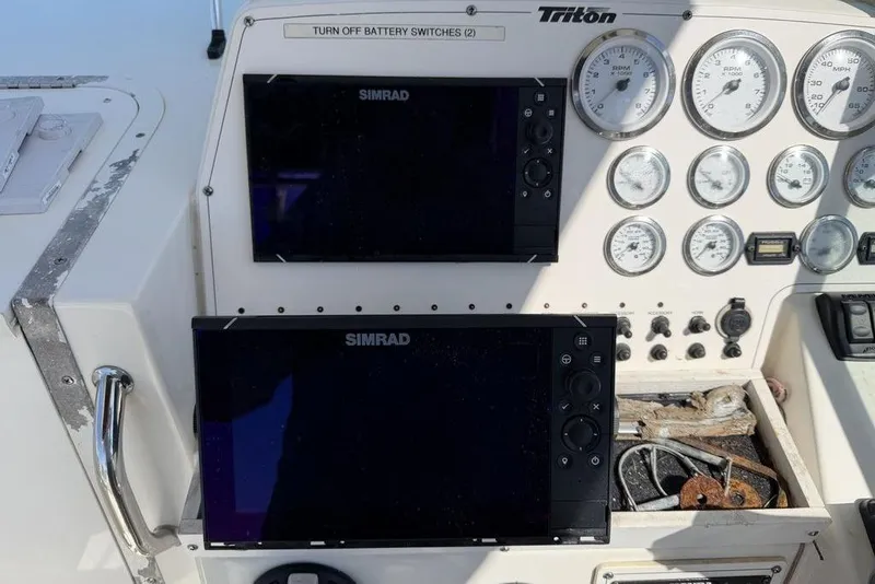 Slide: The Image of Control panel of a 2005 Triton 2486 CC boat with Simrad displays and gauges. - 16