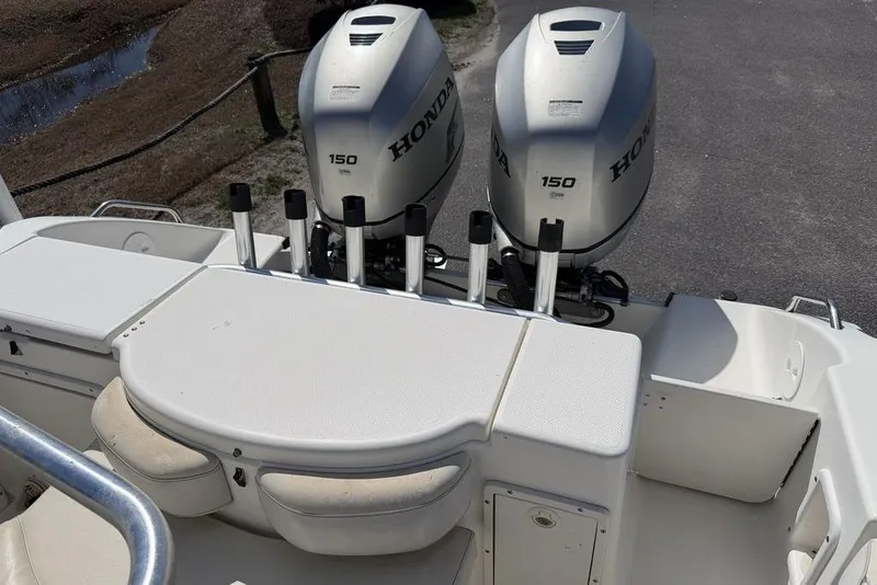 Slide: The Image of 2005 Triton 2486 CC boat with dual Honda 150 engines, rear seating, and rod holders. - 19