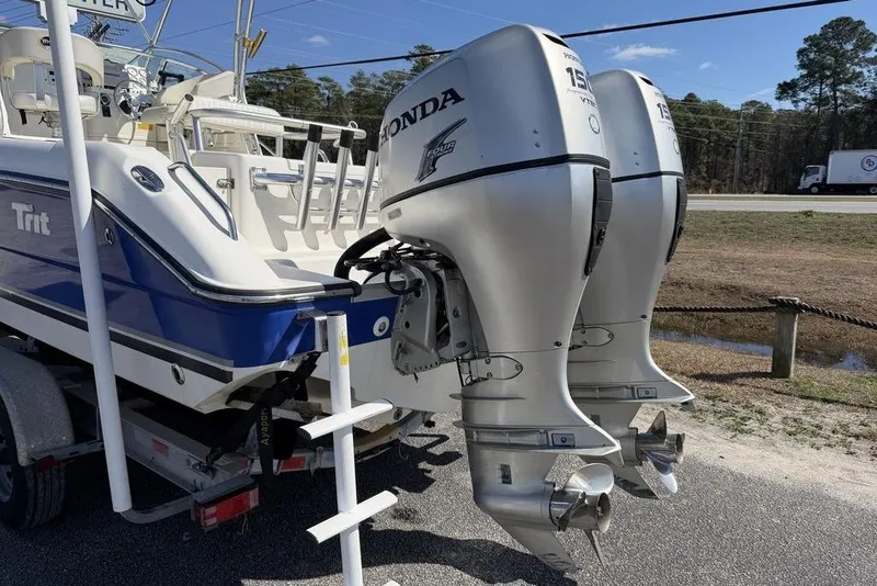 Slide: The Image of 2005 Triton 2486 CC boat with dual Honda outboard motors on a trailer. - 8