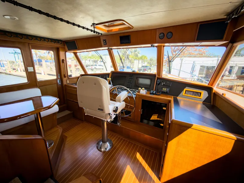 Slide: The Image of Interior of a 1996 Fleming 55 yacht, featuring helm and wood finish. - 3