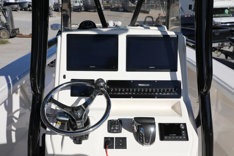 Slide: The Image of 2023 Pathfinder 2700 Open boat dashboard with dual Garmin displays and steering wheel. - 11