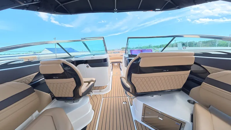 Slide: The Image of Interior view of a modern boat with sleek seating and a clear sky in the background. - 14