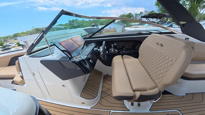 Slide: The Image of The cockpit of a Sea Ray SLX 280 Outboard with beige leather seats and a modern dashboard. - 15