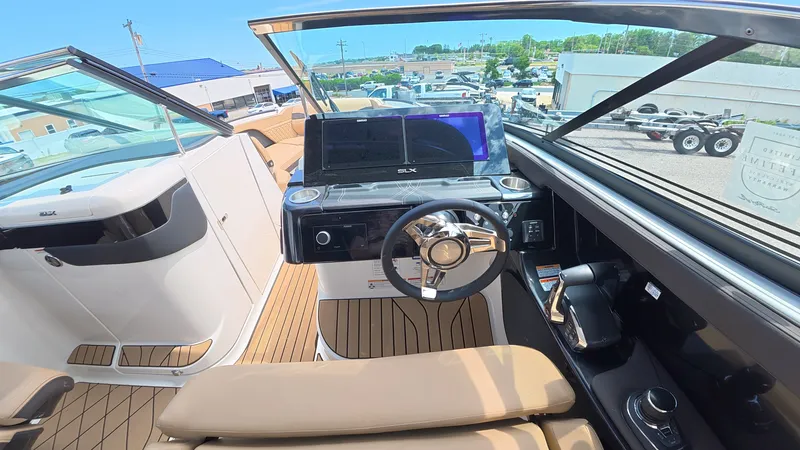 Slide: The Image of The cockpit of a Sea Ray SLX 280 Outboard with a modern steering wheel and dashboard. - 16