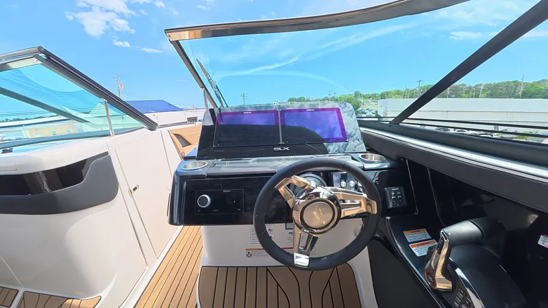 Slide: The Image of The cockpit of a Sea Ray SLX 280 Outboard with a modern steering wheel and dashboard. - 17