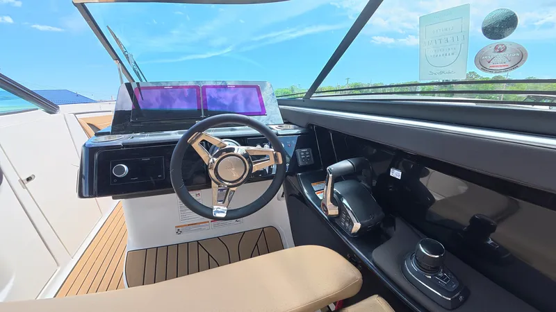 Slide: The Image of The cockpit of a Sea Ray SLX 280 Outboard with a modern steering wheel and dashboard. - 18