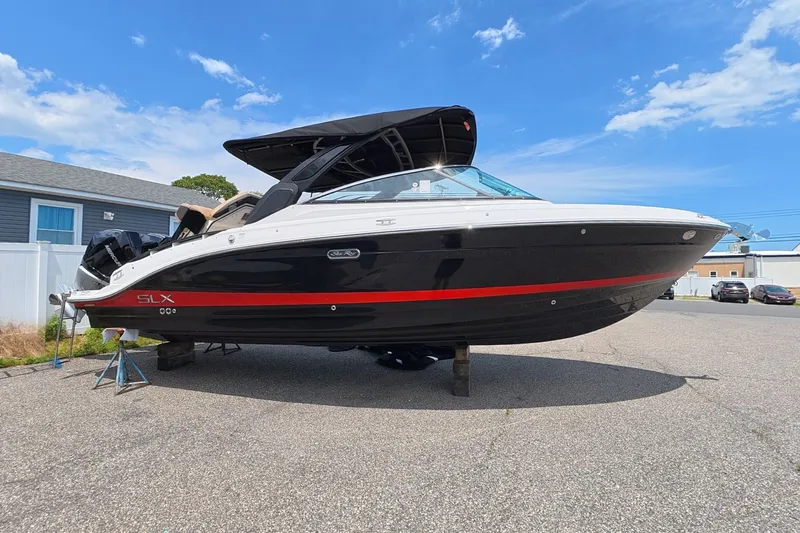 Slide: The Image of A Sea Ray SLX 280 Outboard boat is on a parking lot. - 1