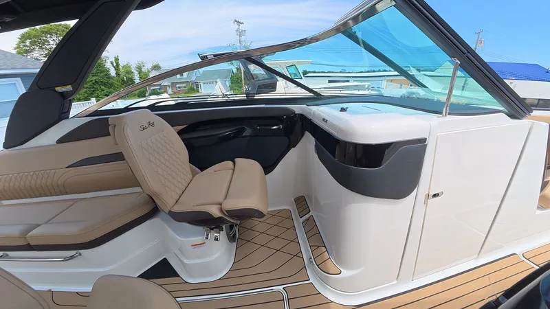 Slide: The Image of The cockpit of a Sea Ray SLX 280 Outboard with beige seats and modern design. - 19